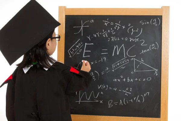 Asian Chinese little girl in graduation gown againts blackboard — Stock Photo, Image