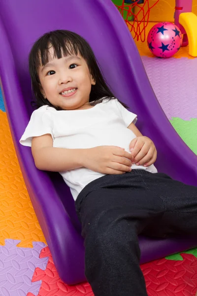 Asian Chinese little girl playing on the slide — Stock Photo, Image