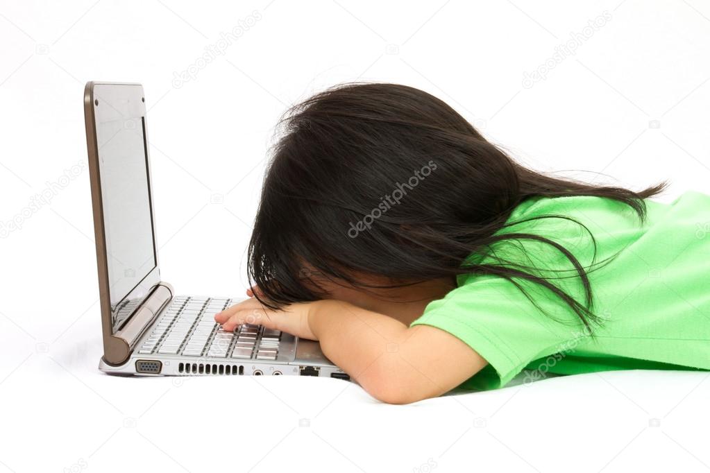 Chinese little girl sleep in front of a laptop