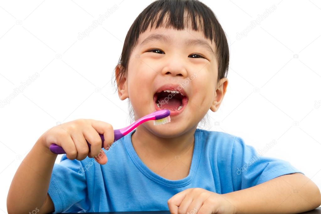 Chinese little girl brushing teeth