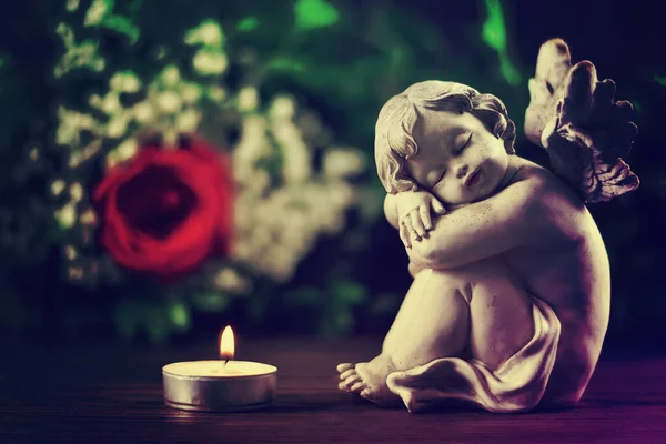 Condolence card with sleeping angel and burning candle