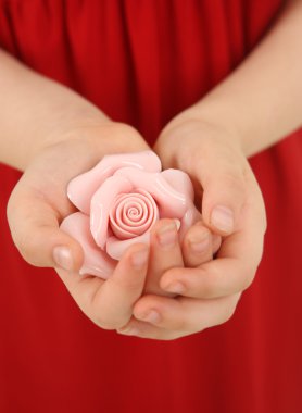 Ceramic rose in hands