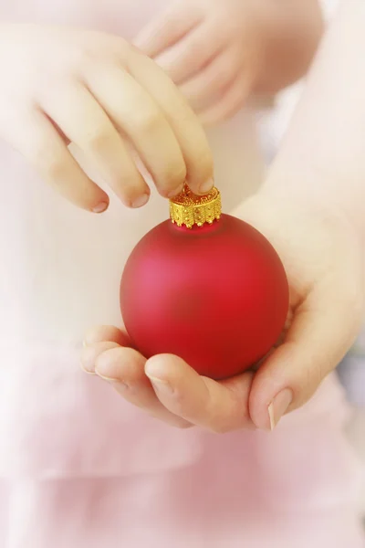 Hands with Christmas bauble — Stock Photo, Image