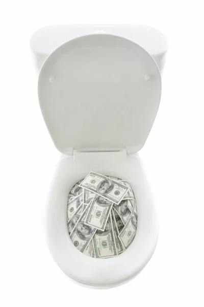 Dollar banknotes in toilet bowl — Stock Photo, Image