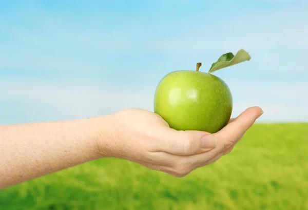 Green Apple in hand — Stock Photo, Image