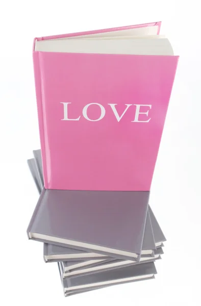 Pila de libros y uno con inscripción de Amor — Foto de Stock
