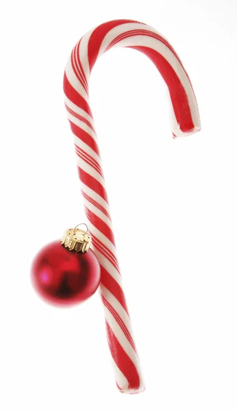 Candy cane with christmas bauble — Stock Photo, Image