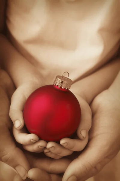 Christmas Bauble in hands — Stock Photo, Image