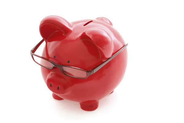 Banco piggy vermelho em óculos — Fotografia de Stock