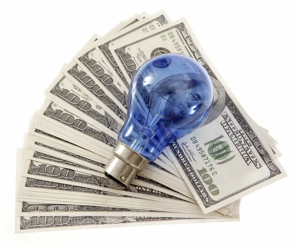 Light bulb on dollars banknotes — Stock Photo, Image