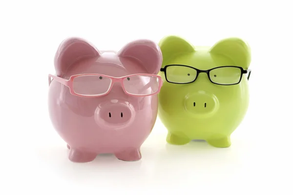 Two Piggy Banks in glasses — Stock Photo, Image