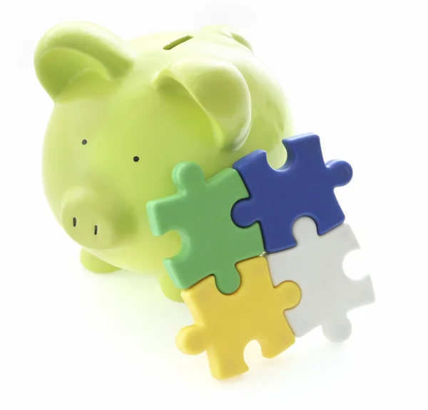 Piggy Bank with puzzle elements — Stock Photo, Image