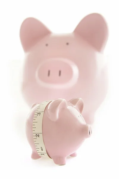 Piggy Banks and measuring tape — Stock Photo, Image