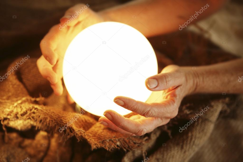 Crystal ball in human hands