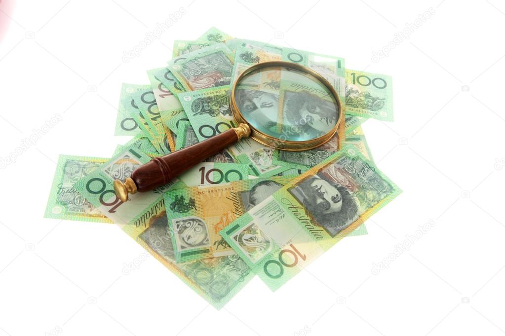 Australian Money and magnifying glass