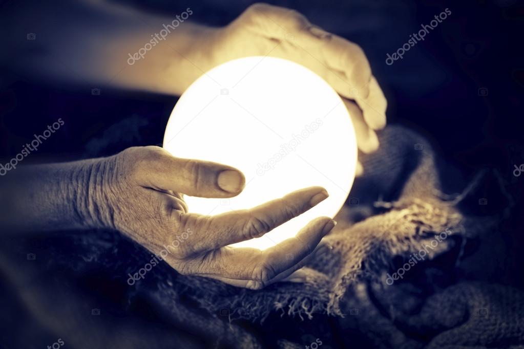 Crystal ball in human hands