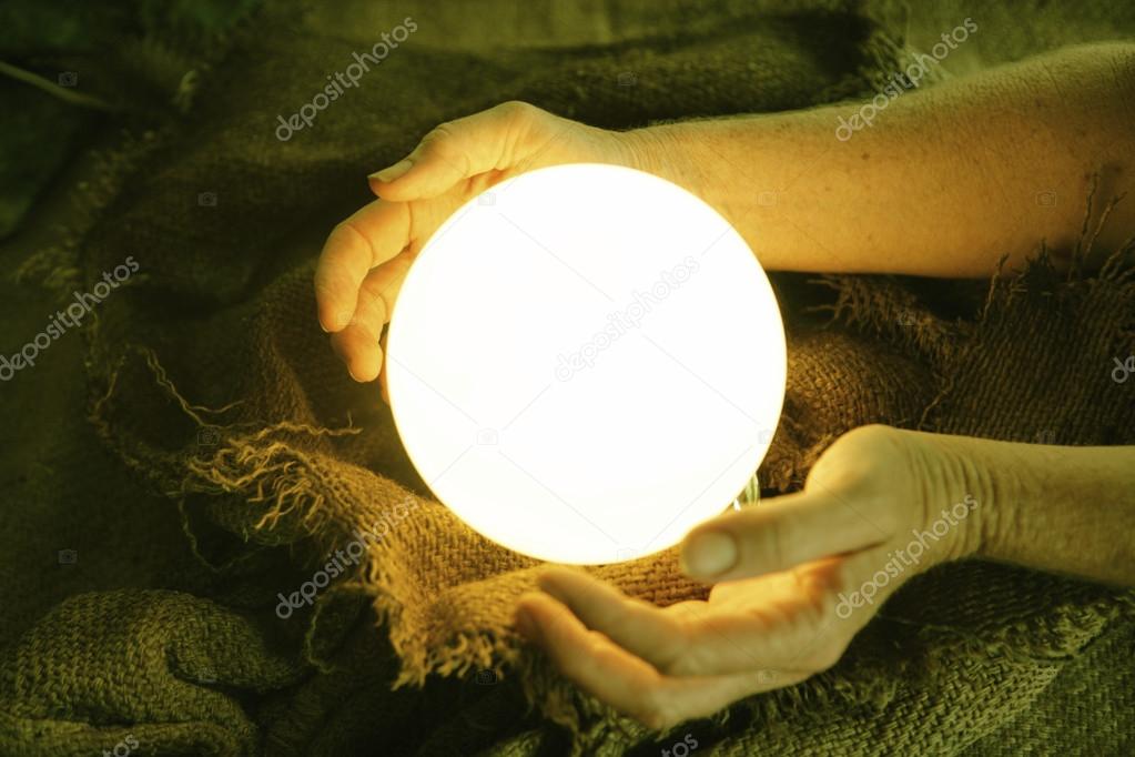 Crystal ball in human hands