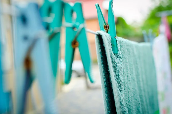 blue pins on rope and a hanging towel