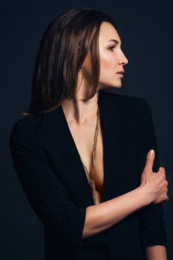 Koyu mavi arka planda siyah ceketli esmer bir kız.