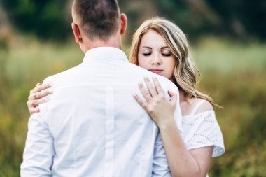 Dünya 'nın yeşil bir kanyonunun arka planında hafif elbiseli bir kızla bir adam.