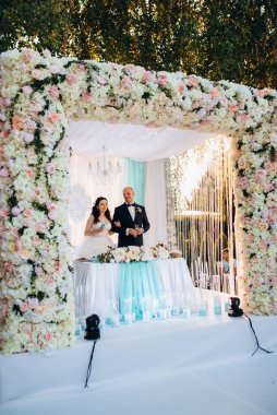 Yeni evlilerin portresi düğün şöleninde başkanlık makamında.