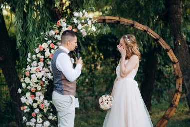 Ormandaki yeşil bir çayırda aşık genç bir çiftin düğün töreni.