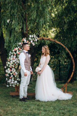 Ormandaki yeşil bir çayırda aşık genç bir çiftin düğün töreni.