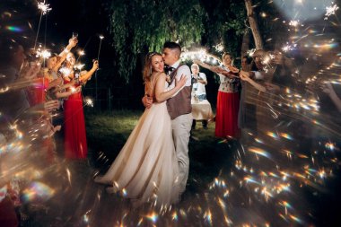 newlyweds at a wedding in the corridor of sparklers