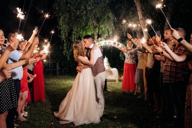 newlyweds at a wedding in the corridor of sparklers