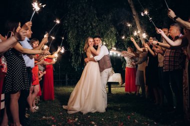 newlyweds at a wedding in the corridor of sparklers