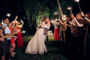 newlyweds at a wedding in the corridor of sparklers
