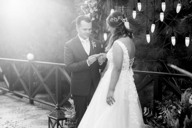 wedding ceremony of the newlyweds on the glade near the restaurant