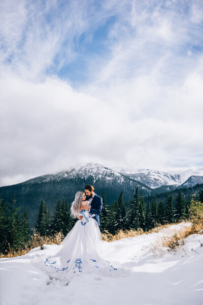 groom in a blue suit and bride in white in the mountains Carpath