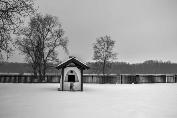 View of an outdoor wood-burning bread oven placed in a village house backyard