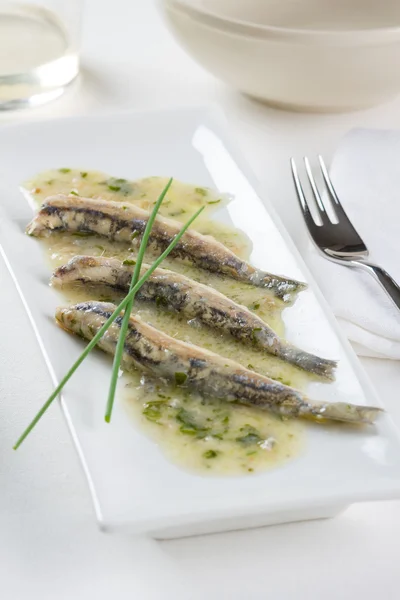 Marinated anchovies in garlic, parsley and olive oil