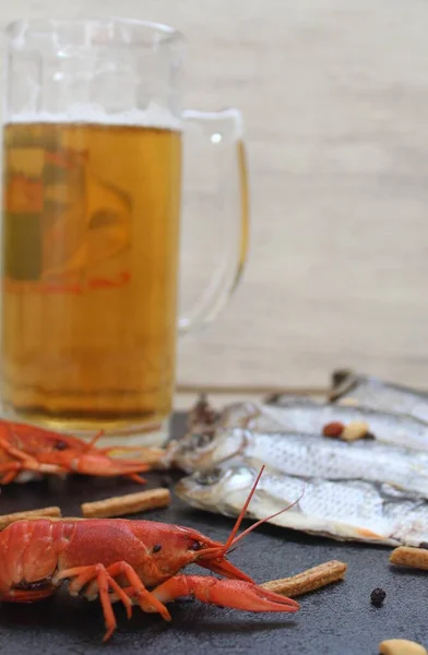 On a white background, a black board.Where to exchange a glass of cold beer and seafoodFish, crayfish and quick snacks. Focus on marine product - red crayfish