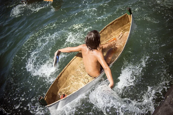 Boy enjoying into a boat. — Zdjęcie stockowe