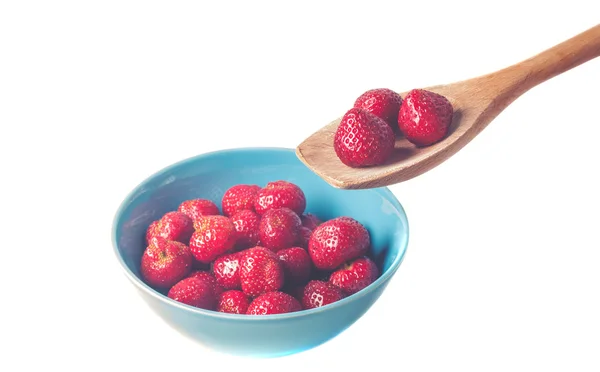 Fresh, juicy strawberries in a bowl and wooden spoon — Stock Photo, Image