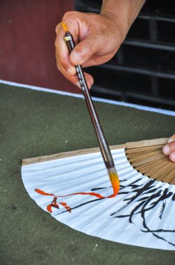 Budist keşiş haeinsa tapınağı gayasan milli parkı yakınlarında Güney Kore 'nin Gyeongsang eyaleti yakınlarında Çinli hayranlar tasarlayarak kaligrafi sanatını icra ediyor.