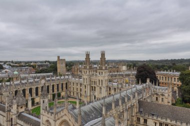 Rooftop view on historical university buildings towards All Souls College, Oxford, United Kingdom. Overcast sky.