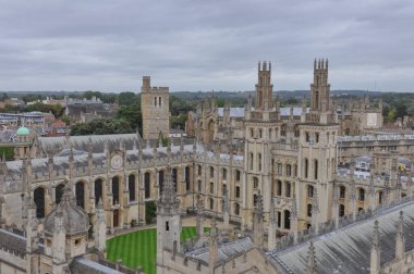 Rooftop view on historical university buildings towards All Souls College, Oxford, United Kingdom. Overcast sky.