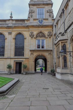 View of english lawn and building facade from Trinity College Durham Quad, Oxford, United Kingdom. Overcast Sky.