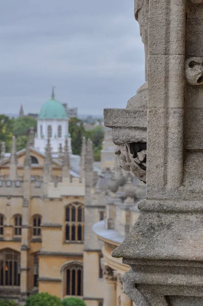 Rooftop view on historical university buildings towards the Sheldonian Theatre, Oxford, United Kingdom. Overcast sky. Selective Focus.