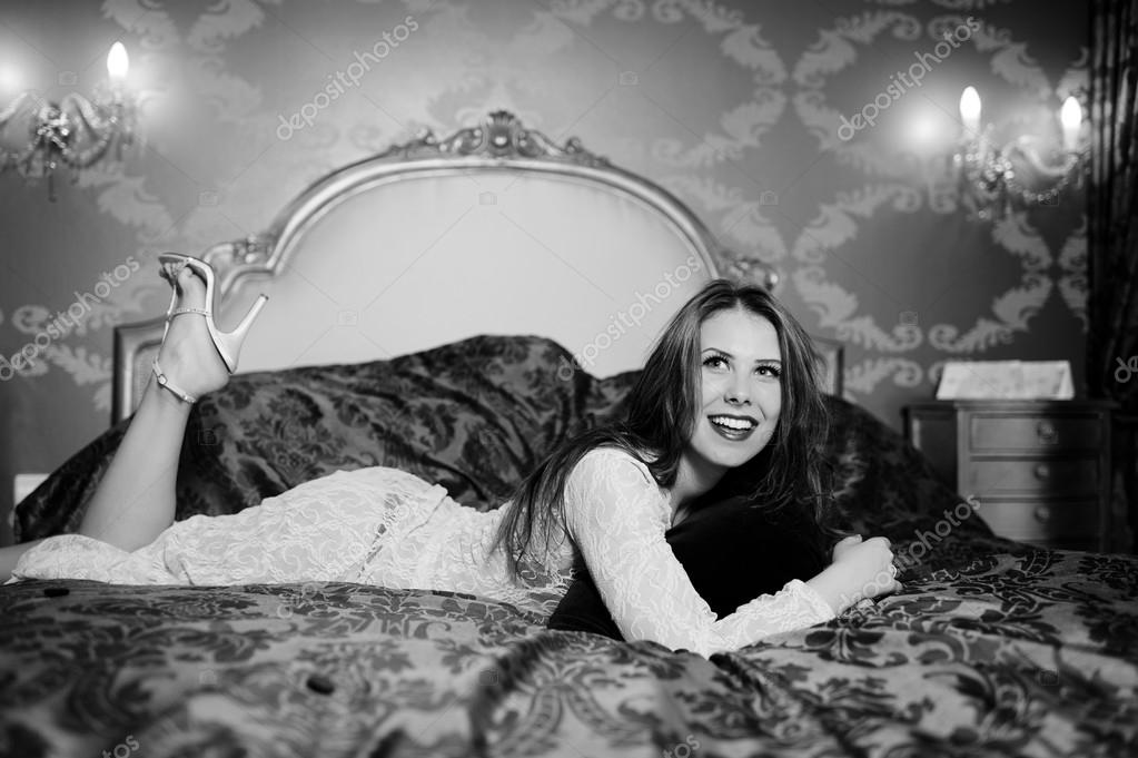 Black and white photography of beautiful young lady relaxing lying in