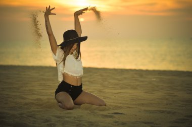 Genç zarif güzel bayan plaj şafak açık havada şapkalı arka plan, portre