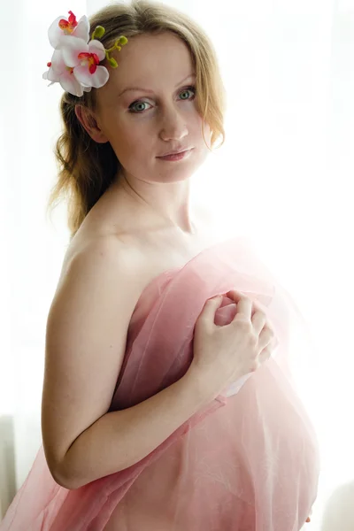 Pregnant beautiful young woman on light copy space background, closeup picture — Stock Photo, Image