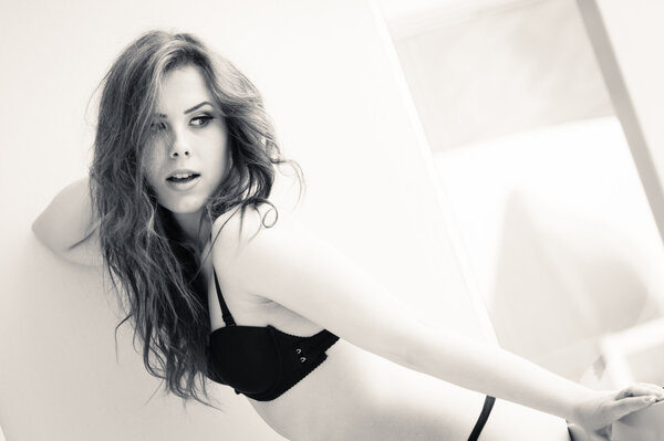 Portrait of sexy beautiful young lady in lingerie over light background