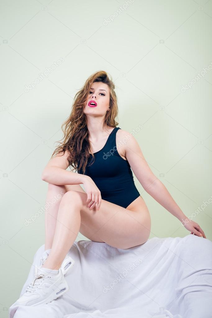 Portrait of sexy beautiful young lady with perfectly fit body looking at camera 
