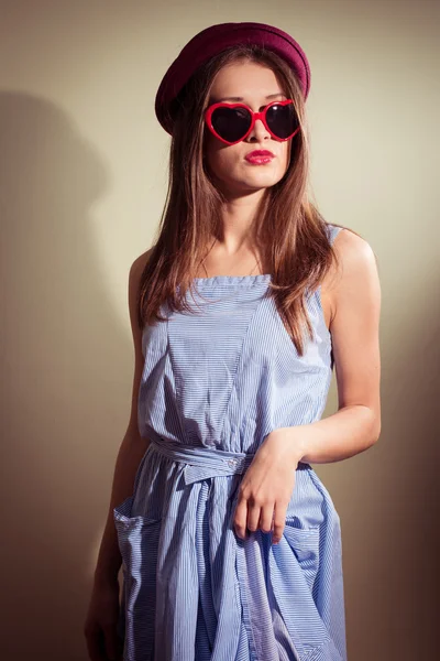 Portrait of sexy girl with glasses in the shape of hearts and blue dress — Stock Photo, Image