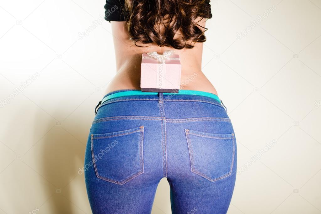 closeup picture of beautiful glamor woman body hips shape and pink present box